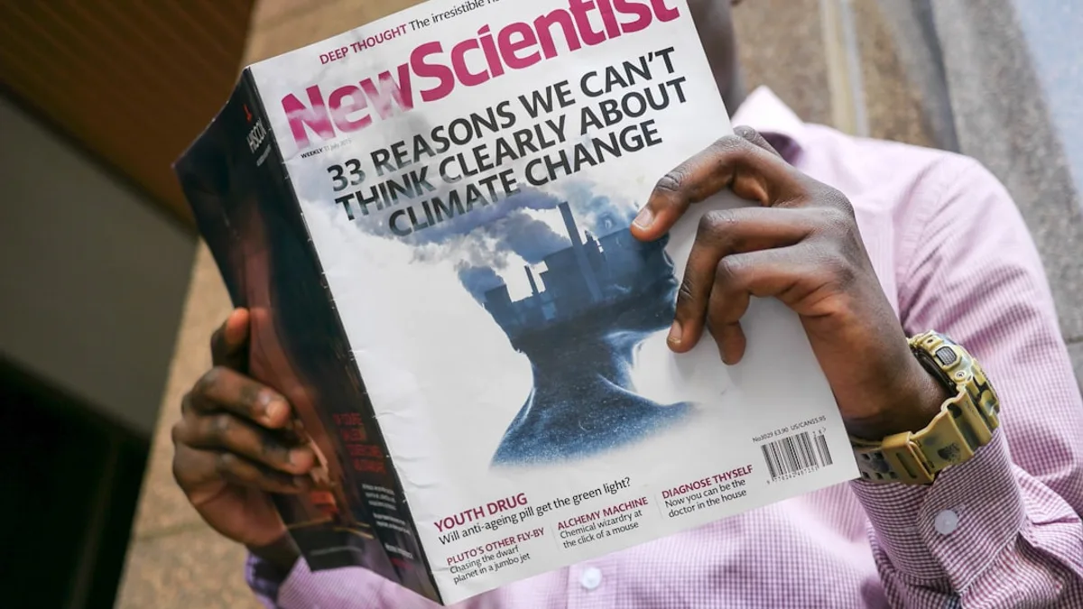 man reading New Scientist book