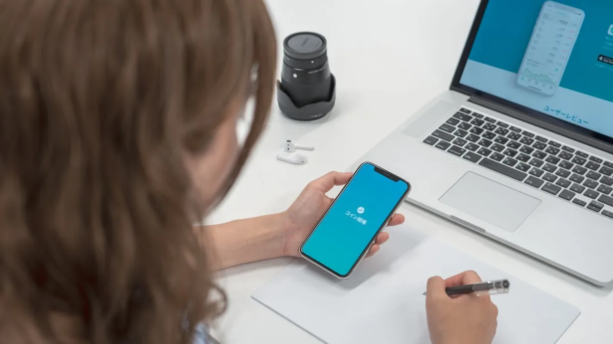 woman holding smartphone while writting