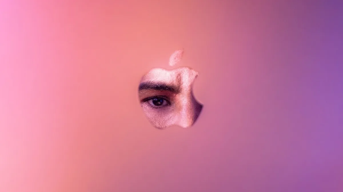 a close up of an apple logo with a person's eye