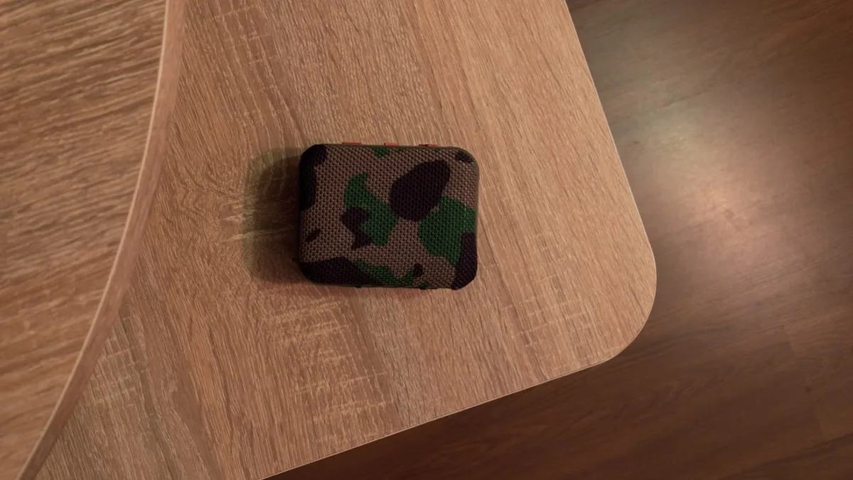 Camouflage patterned object on a wooden surface