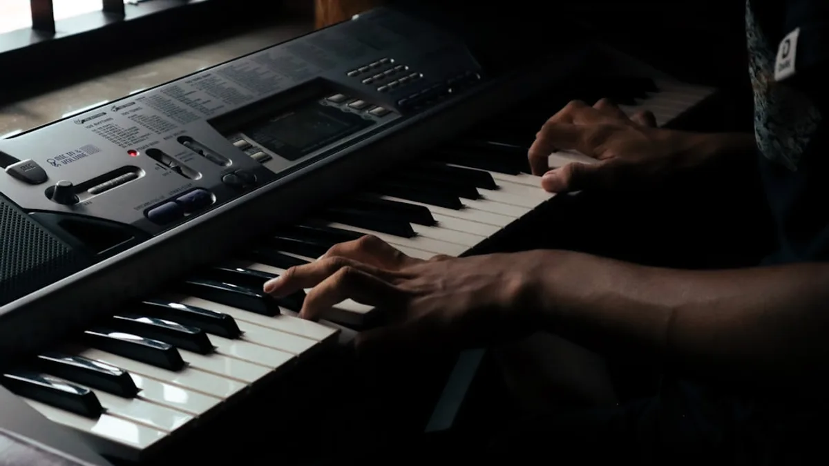 a person sitting at a keyboard with their hands on it