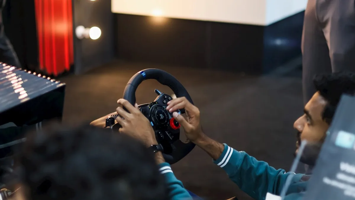 Man playing racing simulator with steering wheel