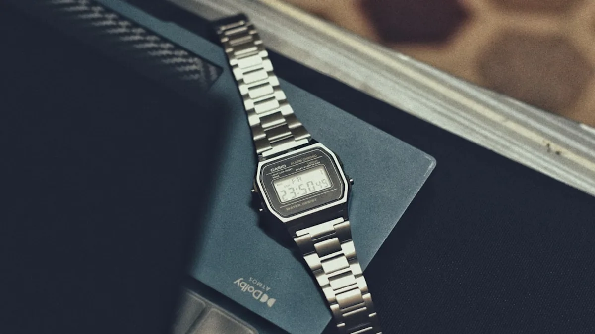 a watch sitting on top of a book on a table