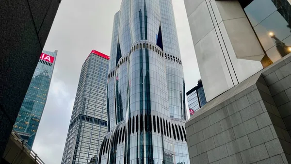 Modern skyscrapers in a city under cloudy sky