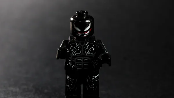 A black lego figure with white venom markings.