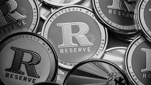 a pile of silver and black coins