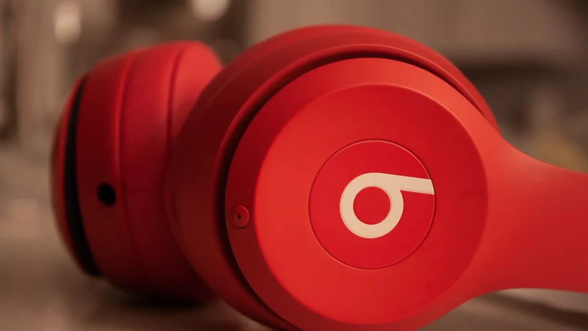 a pair of red headphones sitting on top of a counter