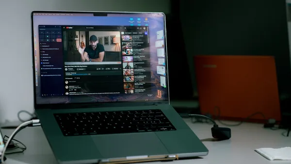 a laptop computer sitting on top of a white desk