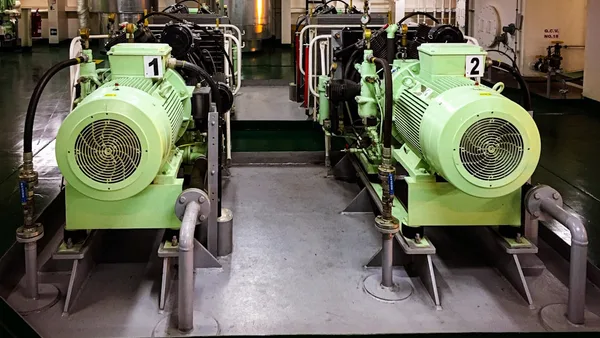 a couple of green machines sitting inside of a building