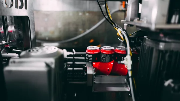 a machine with red and white cans