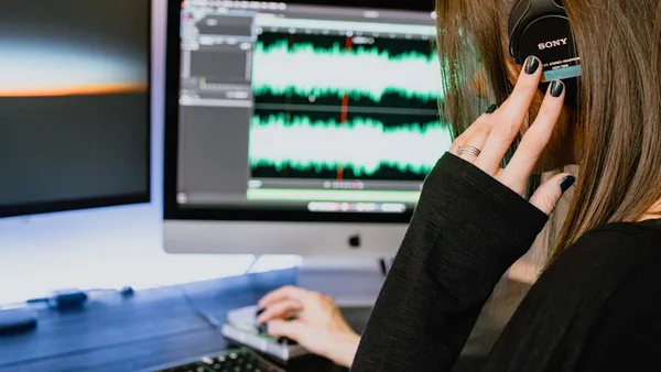 woman in black long sleeve shirt using black laptop computer