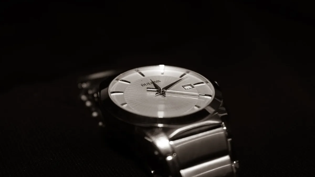 a silver watch with a black background