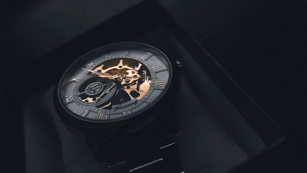 a watch sitting on top of a black box