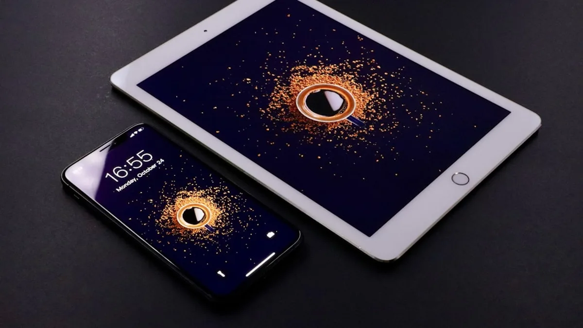 gold Apple iPad and black smartphone