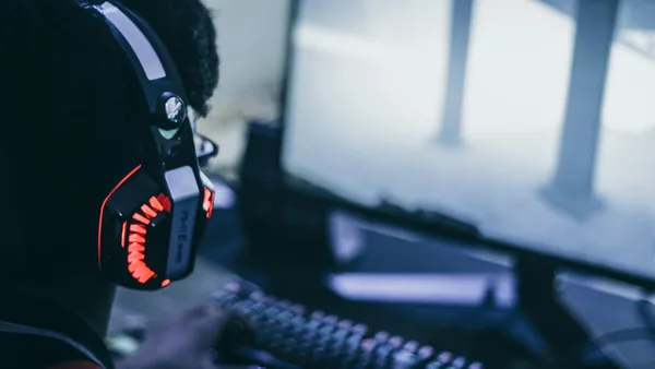 person wearing orange and black headphones