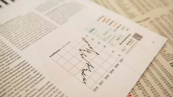financial newspaper with stock chart