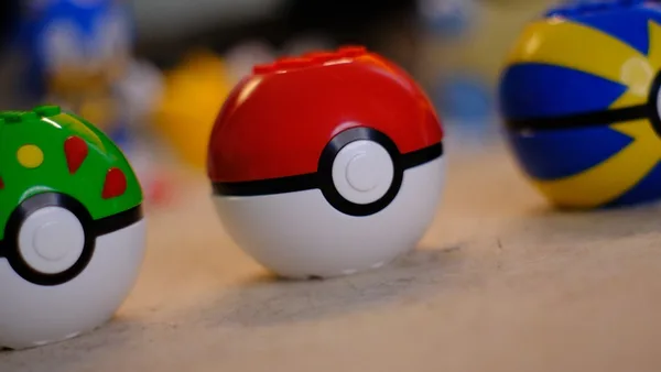 Three colorful toy balls, including a red and white pokeball.