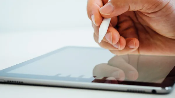 person holding white stylus pen