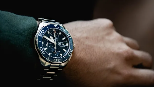 round black chronograph watch at 5:50