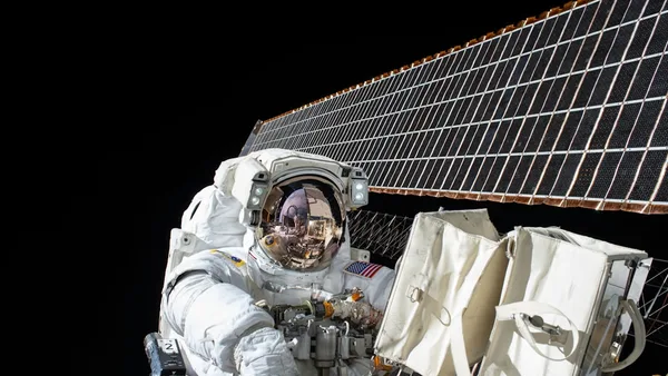 photography of Astronaut beside satellite