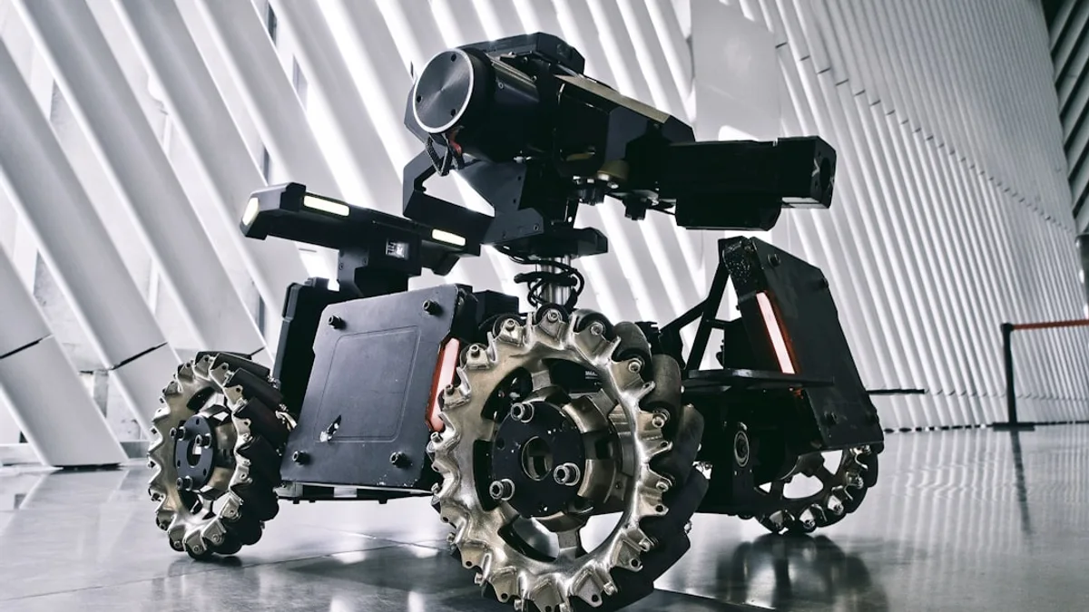 A black and white photo of a camera on wheels