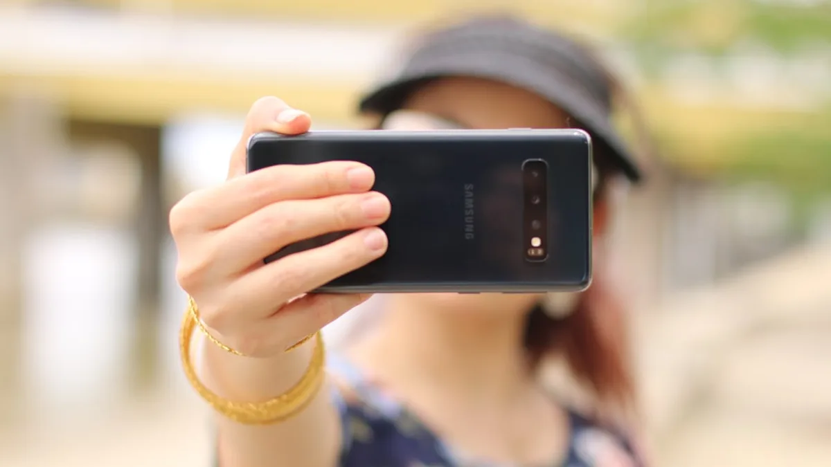 woman showing black Samsung smartphone