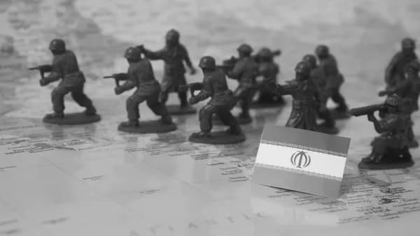 Toy soldiers and iranian flag on map