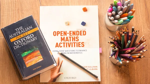 person holding a book and pen