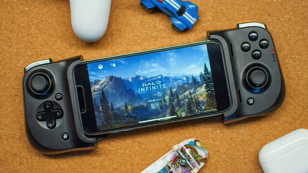 a game controller sitting next to a smart phone