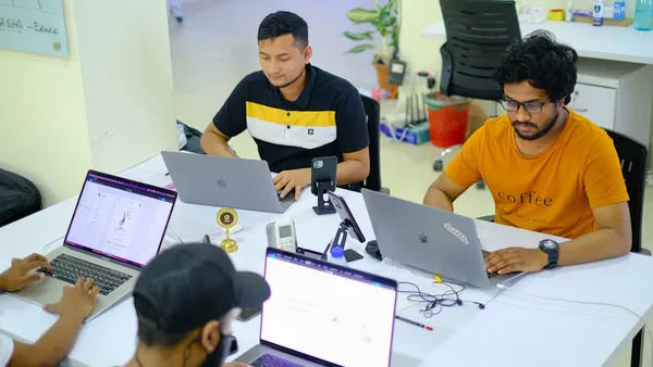 people sitting at the table using laptops