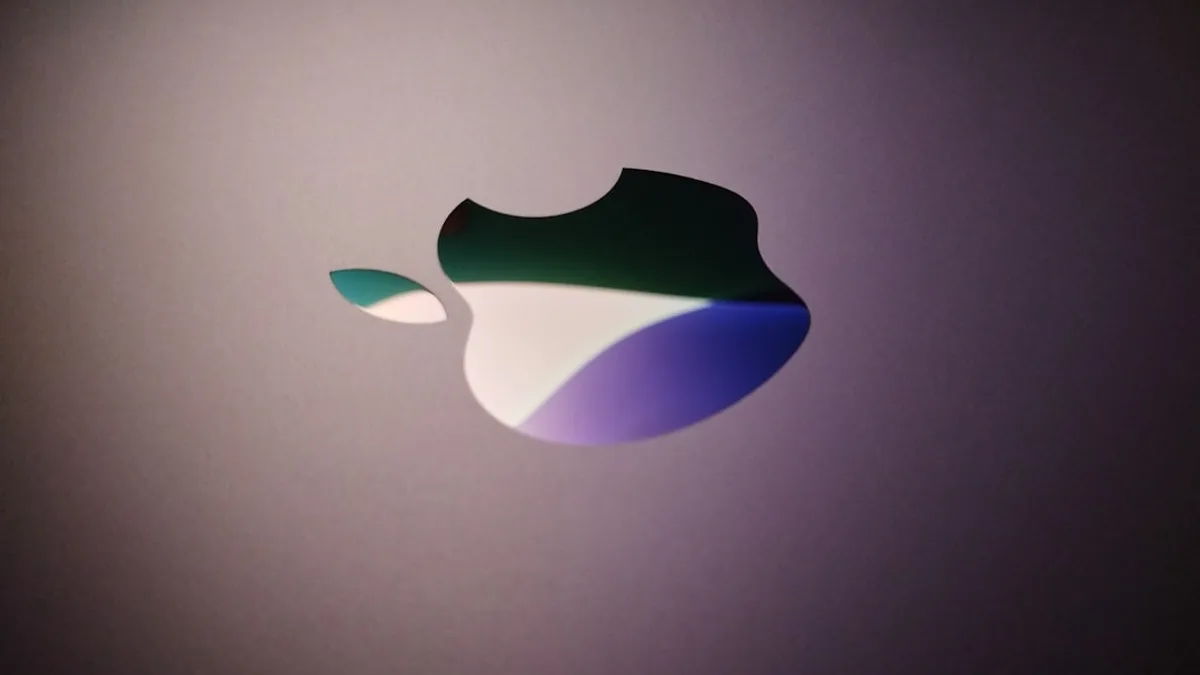 Close-up of an apple logo with colorful reflections