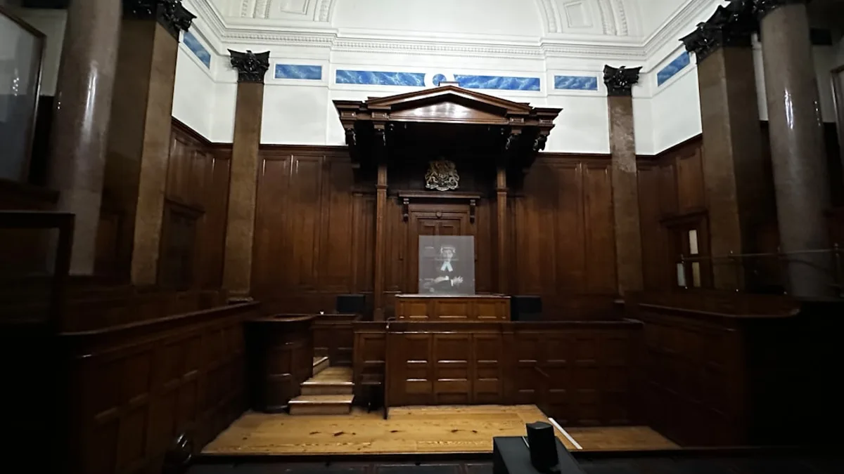 an empty courtroom with wooden paneling and columns