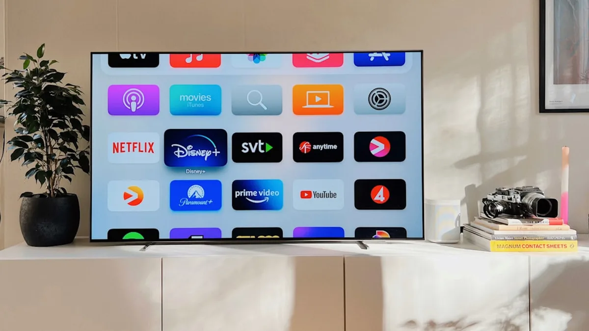 a flat screen tv sitting on top of a white cabinet
