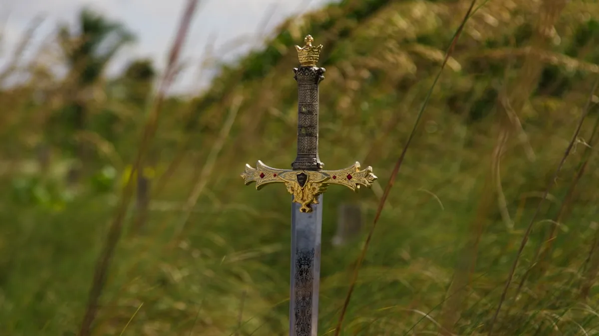 gray steel sword on ground during daytime