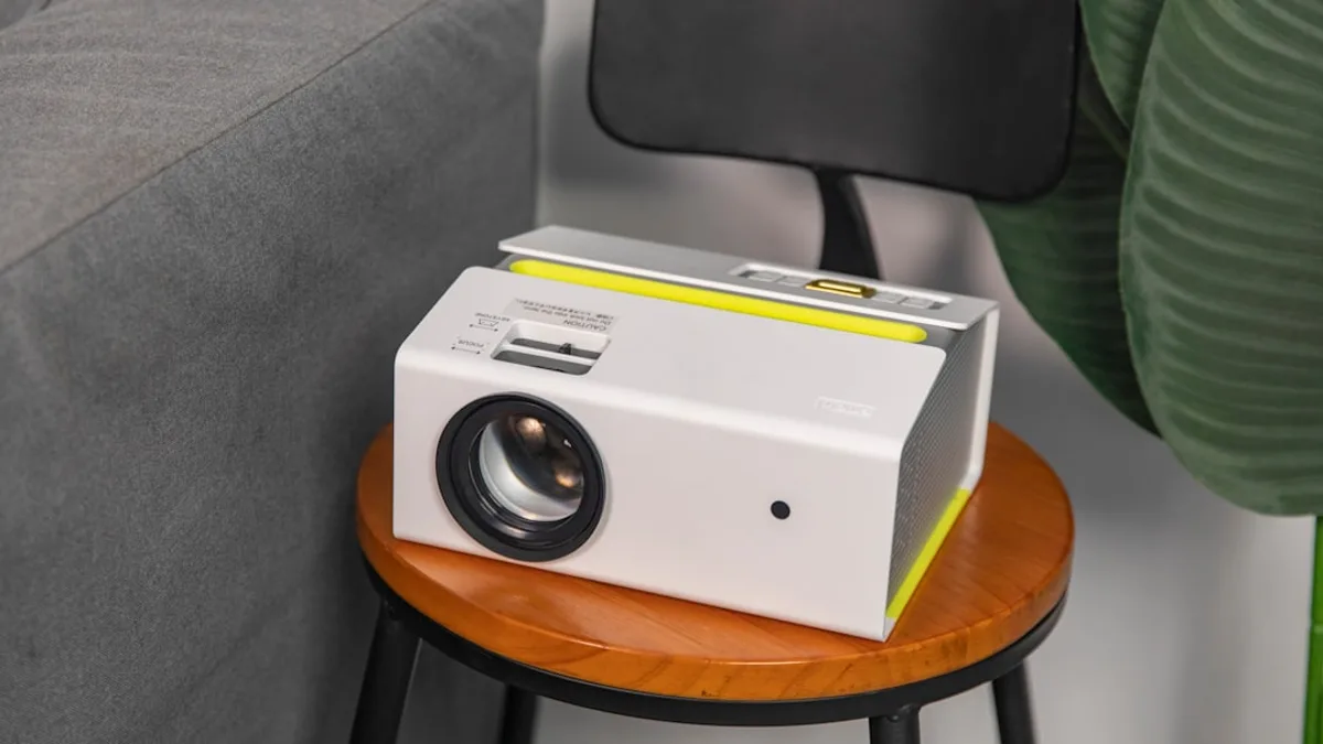 a white projector sitting on top of a wooden table