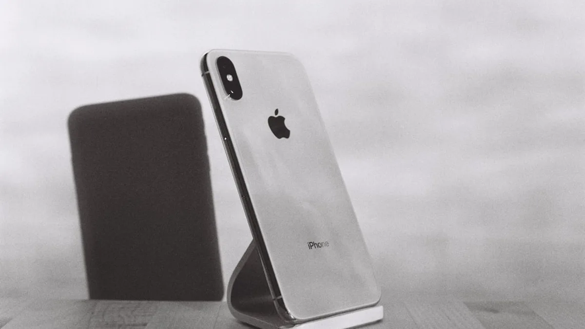 silver iPhone X on stand