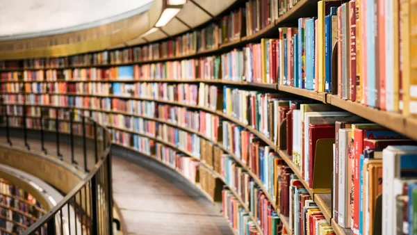 books on brown wooden shelf