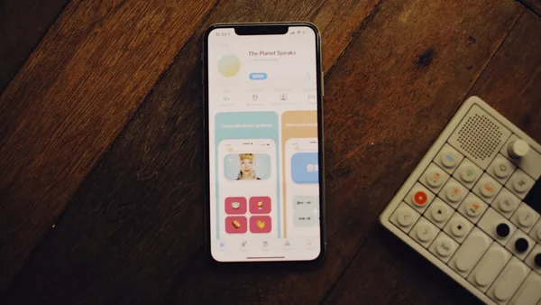 a cell phone sitting next to a remote control