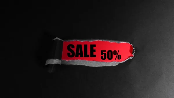 Red tag with "sale 50%" text on black background