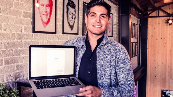 man holding MacBook Pro