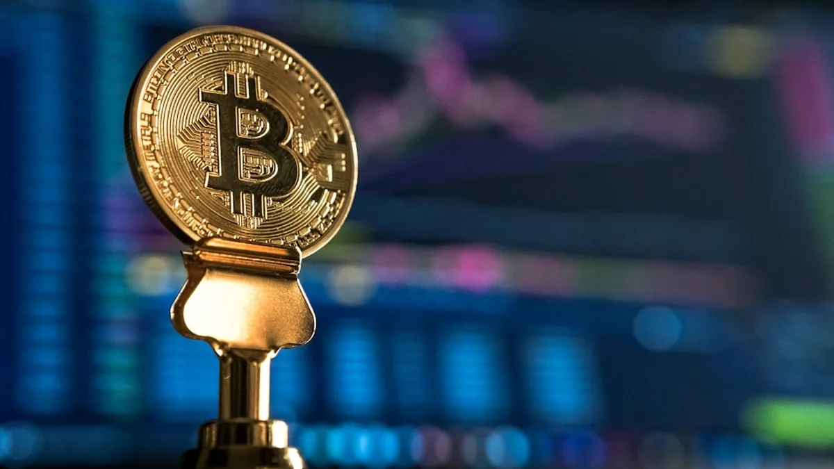 selective focus photo of Bitcoin near monitor