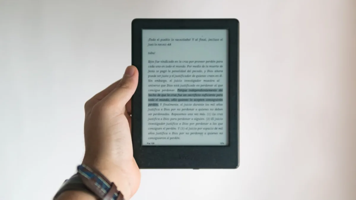 person holding black e book reader