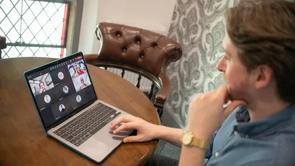 Man on laptop participating in a video conference call.