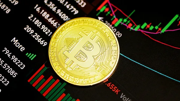 gold round coin on black surface