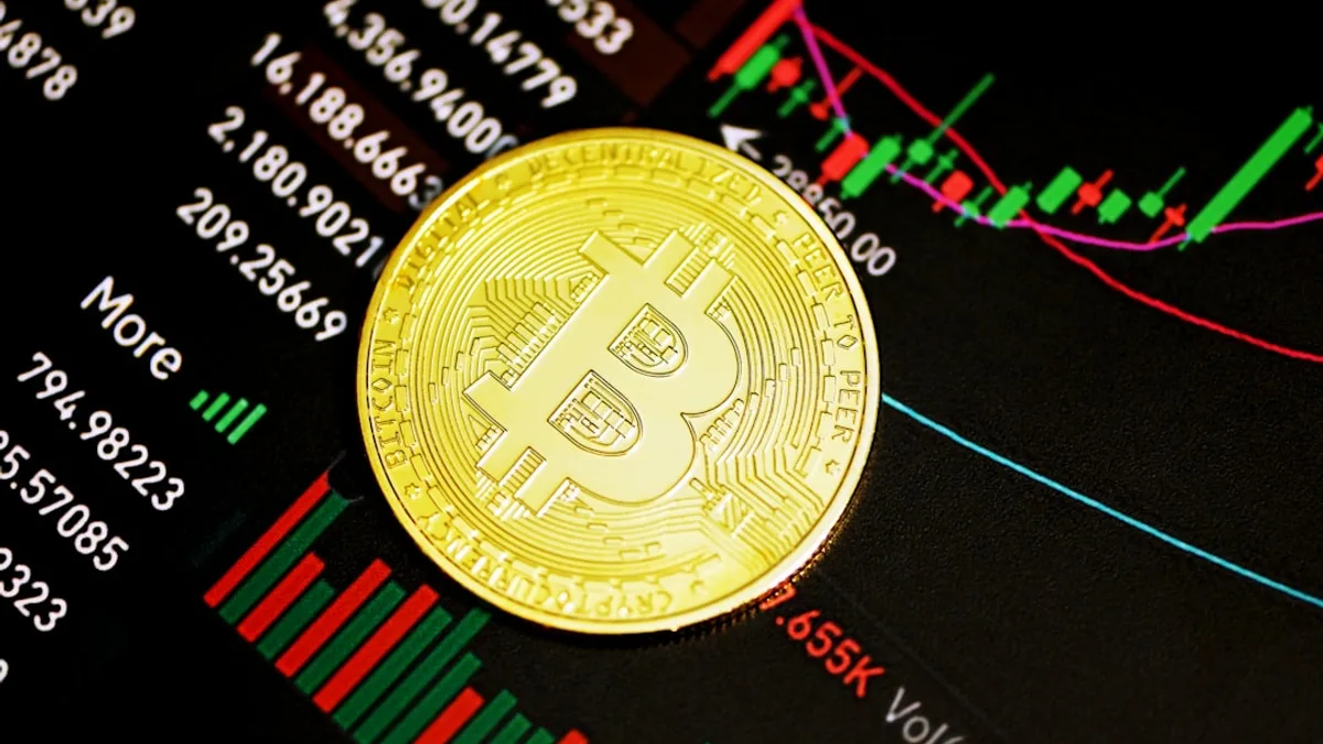 gold round coin on black surface