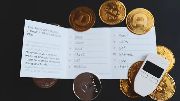a cell phone sitting on top of a pile of coins