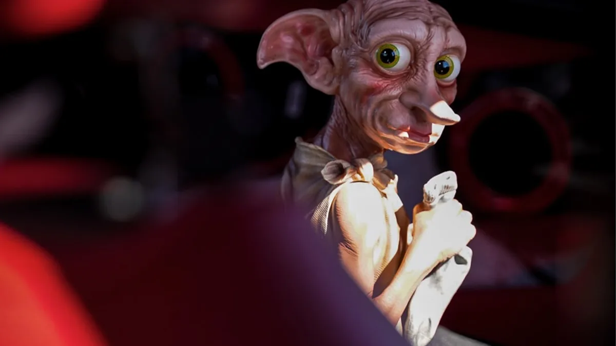 a close up of a cat statue on a car seat