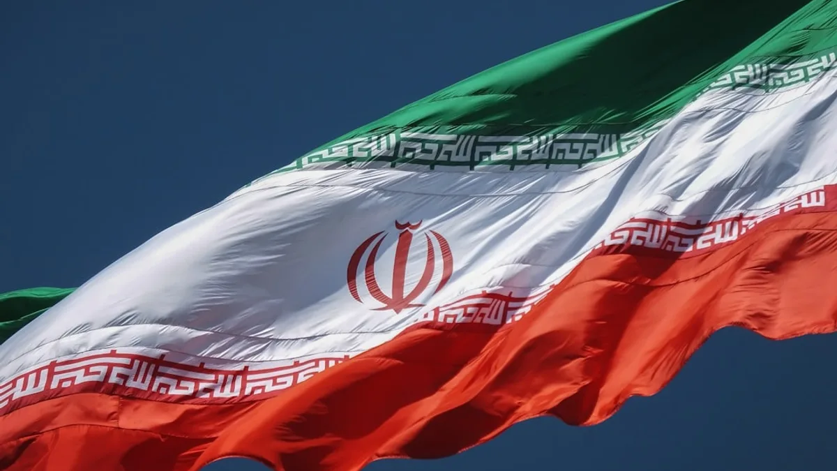 the flag of the country of iraq flying in the sky
