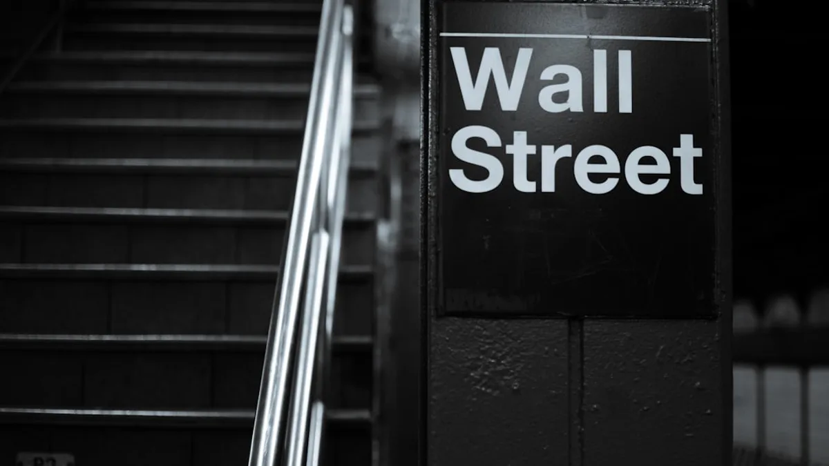 a black and white photo of a wall street sign