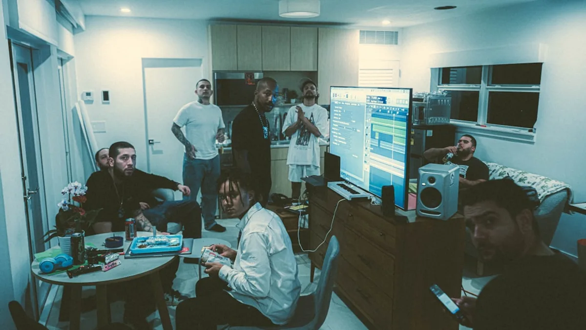 a group of people standing and sitting around a living room